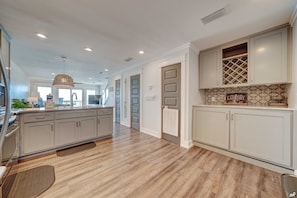 The wine pantry area conveniently houses a brand-new washer and dryer tucked underneath, combining practicality with sophistication.