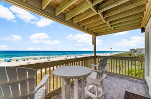 The balcony provides a breathtaking view of the Emerald Coast and the Gulf of America, offering a serene escape.