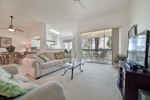 PS202 - Spacious and light living with comfortable seating and flat screen TV. Sliding doors open up to the screened in lanai