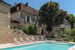 swimming pool with Roman staircase, terrace with pink chestnut tree