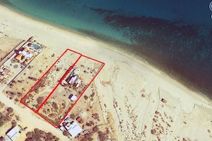 Beachfront on a very quiet beautiful sand beach (entire property in red)