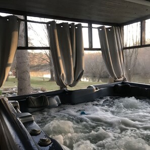 Hot tub with view to fenced yard and disc  golf. 