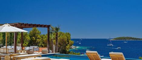 Luxury Croatia sea view villa with private pool surrounded by deckchairs for vacation and rent