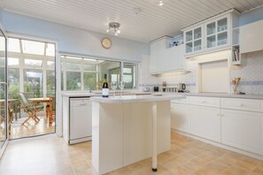 Kitchen leading onto sun room and terrace