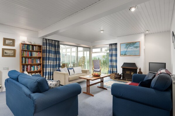 Living room with real fireplace and river views