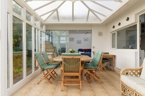 Sunroom with large dining table