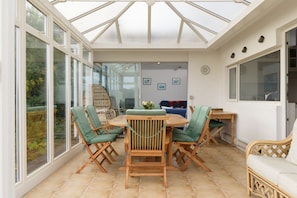 Sunroom with large dining table