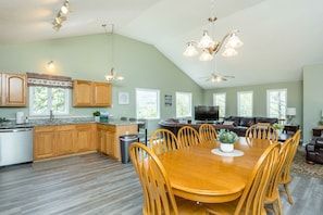 Great room open to the well appointed kitchen and dining room with large table, additional chairs available