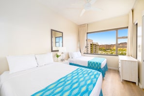 Bedroom with 1 queen-size and 1 full-size bed, and a ceiling fan