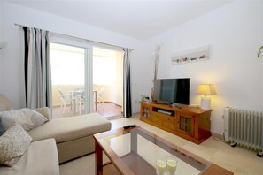 Bright and spacious living room with comfortable seating and air conditioning