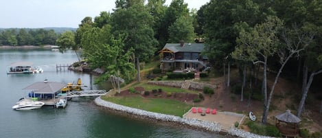 Point lot with dock on left, beach and gazebo on right.  297 ft frontage