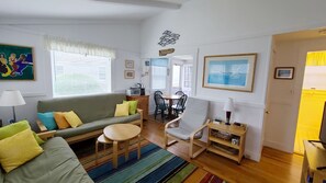 Open and bright living room with futon and TV