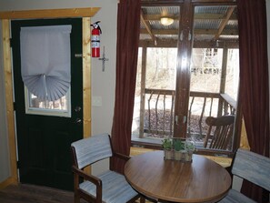 MAIN ROOM:  Features a small dining table with chairs, kitchenette  / sink, one twin-on-full bunk bed, and one twin-on-twin bunk bed.