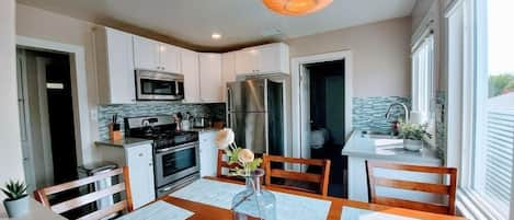 Enjoy the natural light that comes in as you cook in the fully furnished kitchen. 