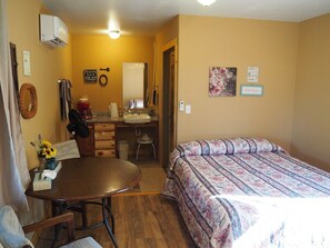 MAIN ROOM:  Features two double beds, small dining table with chairs, and a sink / kitchenette.