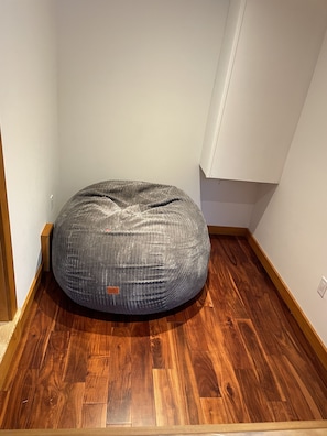 Giant "CordaRoy" bean bag opens up into queen sized bed in kid's nook.