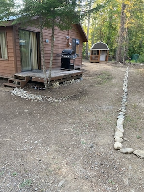Driveway to bunkhouse, parking for 2 cars, rock barrier shows property line