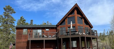 Exterior of the home showing hot tub and two decks