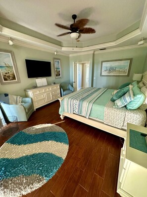 Master Bedroom w 55” TV overlooks the pool and lanai
