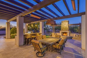 Dine outside at the outdoor fireplace and built-in barbecue area.