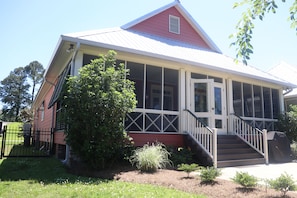 Back view of house and large screened in porch.