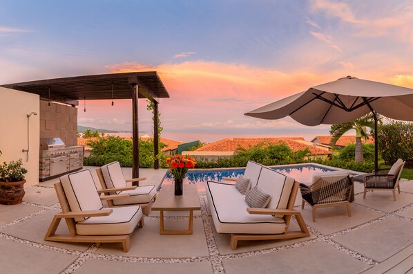 Backyard with pool and  large gas grill