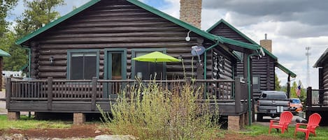 Back side of cabin facing  ponds & meadow area. Just below the Adirondack chairs is  Little Colorado River. A nice place to sit & fish or just enjoy the fresh air. Our porch has 3 cafe  tables and six padded chairs next & propane grill. Gas provided.