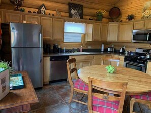 Updated kitchen appliances are stainless steel and black. Gas range and oven, over counter carousel microwave, quiet dishwasher, garbage disposal and full size fridge with freezer. We have a regular coffee brewer, K cup brewer and toaster