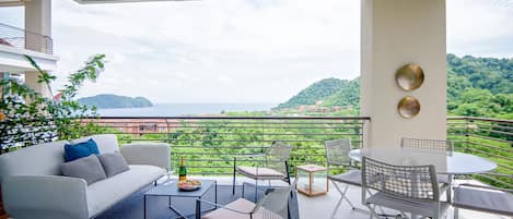 Large balcony with ocean and mountain view.