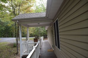 Deck view of portico, walkway, and entrance into house