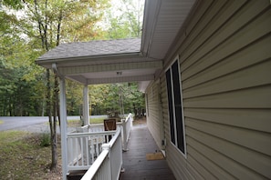Deck view of portico, walkway, and entrance into house