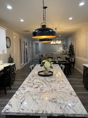 Massive island with built in cabinetry and wrap-around bar-stools.