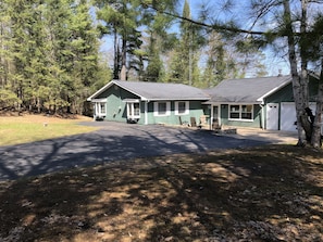 view of home and attached garage, blacktop driveway