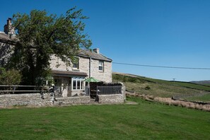 Heatherdene - front aspect with the walled patio and entrance to the cottage
