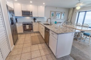 Well-appointed, newly updated kitchen with granite counters and stainless steel appliances