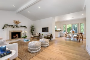 From the front door, open to dining and patio. Gas fireplace and Frame TV.