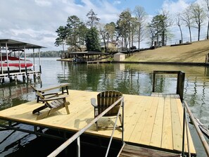 Swim dock w/ two Adirondack chairs & bench leaving space to lay out / play.