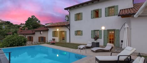 Pool and the back yard in sunset