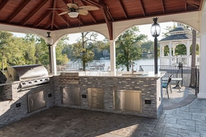 Outdoor kitchen with 2 grills, 2 fire pits and seating areas