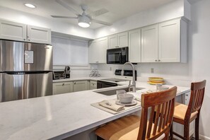 The kitchen offers a breakfast bar with seating for two guests.