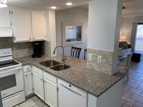 Redesigned pass-through kitchen with new granite and appliances.