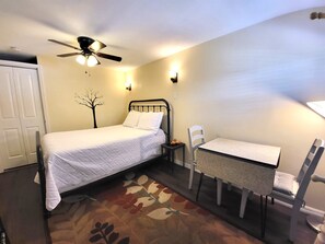 The cottage offers a queen bed and table for 2.