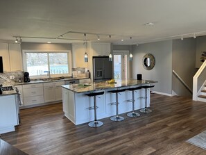 New, huge gourmet kitchen with granite counters and custom lighting.