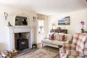 Anvil Cottage - cosy up in front of the wood-burning stove
