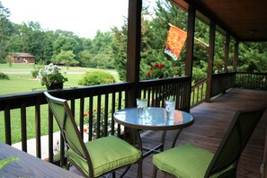 Covered front porch with cafe table and bench.