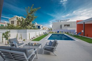 Garden with barbecue, seating area, sun loungers and private pool