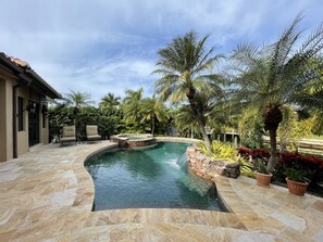 Travertine Pool Deck and Spa with beautiful landscaped yard.