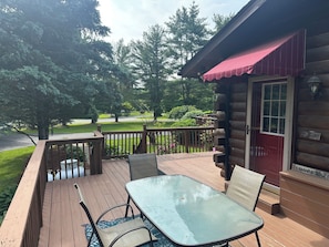 Front deck with table facing front yard.