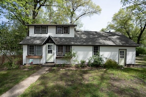 beautiful mature trees form a canopy over the home.

