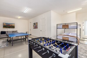 1st floor: 6th Bedroom / Game Room featuring 4 Queen beds (bunk style), Ping Pong, Foosball, SMART TV and game table for your entertainment.